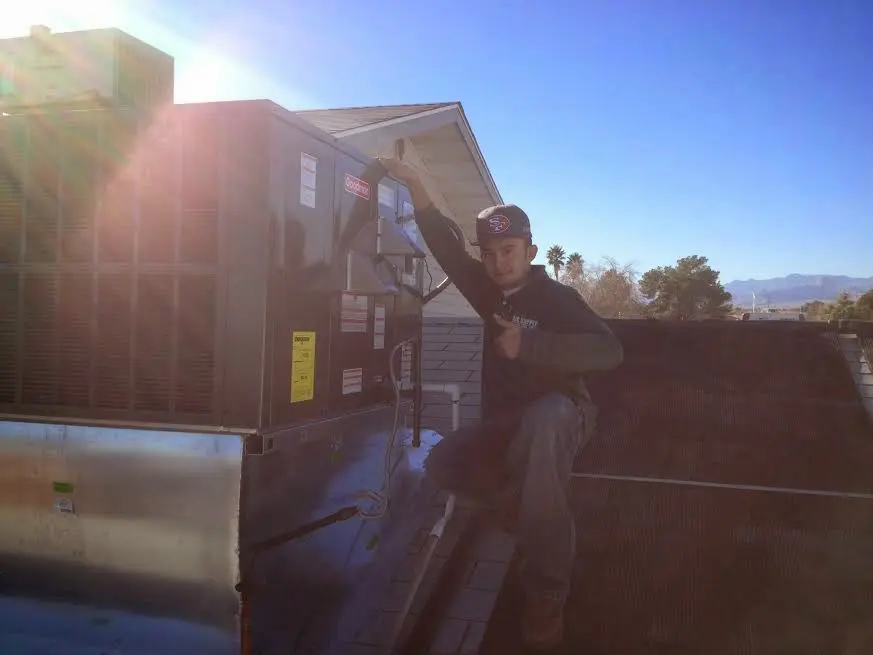 HVAC technician performing HVAC Inspection on a rooftop unit in Brattleboro